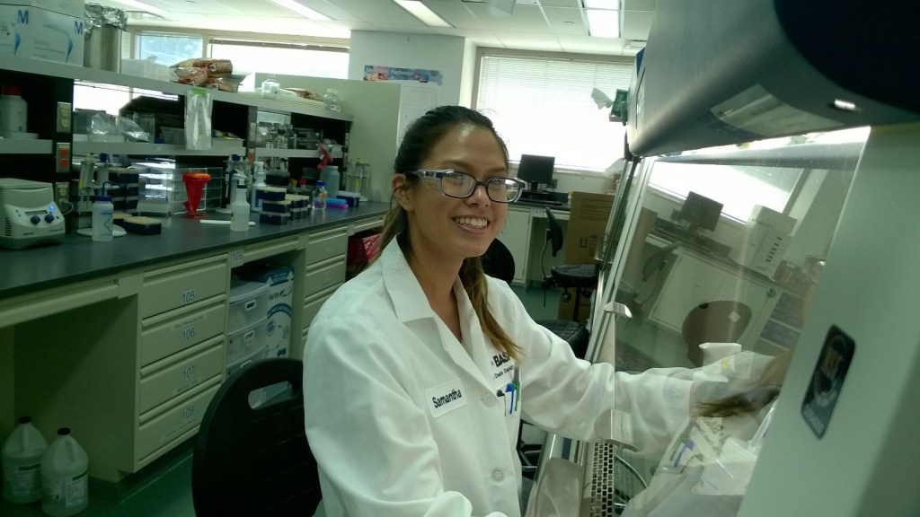 A photo of Samantha Burke working in a biosafety cabinet